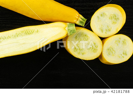 Fresh Raw yellow zucchini on black wood Fresh Raw yellow zucchini on black wood 42181788