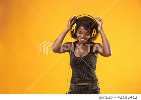 Studio portrait of adorable curly girl happy smiling during photoshoot. Stunning african woman with Studio portrait of adorable curly girl happy smiling during photoshoot. Stunning african woman with 42182412