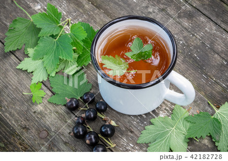 Cup of fruit tea with black currant berries 42182728