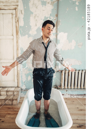 Beginning businessman in flippers stands in bath 42185189