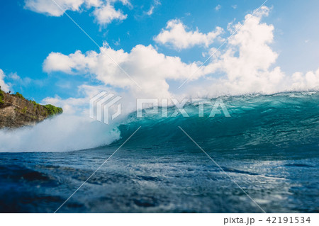Crashing blue wave in ocean. Breaking barrel wave Crashing blue wave in ocean. Breaking barrel wave 42191534