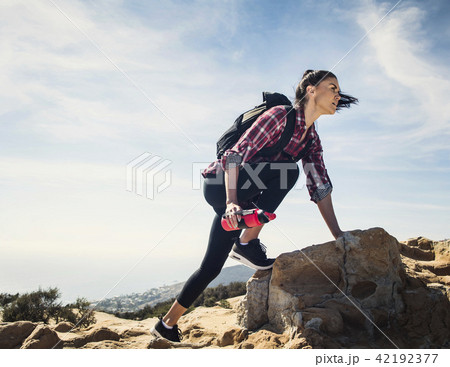 Woman hiking over rocks 42192377