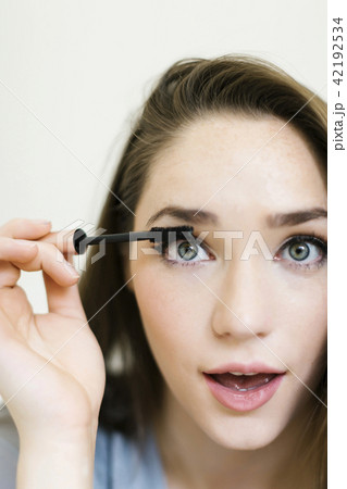 Woman applying mascara Woman applying mascara 42192534