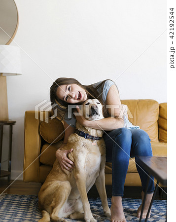 Woman on sofa with dog Woman on sofa with dog 42192544