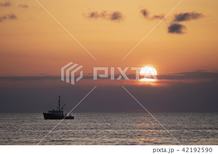 Fishing boat at sunset 42192590
