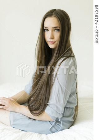 Portrait of young woman with long brown hair Portrait of young woman with long brown hair 42192598