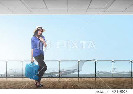 Smiling asian female traveler carrying suitcase 42198024