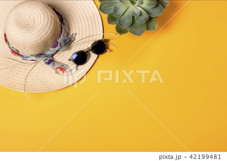 Colorful summer female fashion with hat on yellow background Colorful summer female fashion with hat on yellow background 42199481
