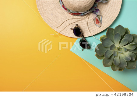 Colorful summer female fashion with hat on yellow background Colorful summer female fashion with hat on yellow background 42199504