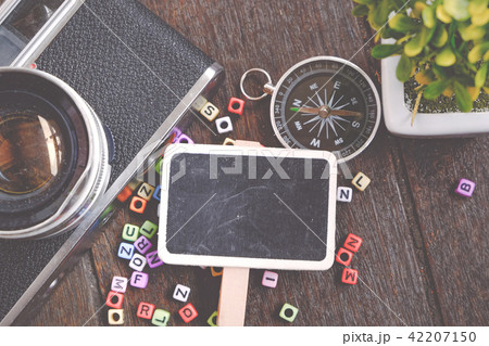 flat lay view signage, camera and compass 42207150