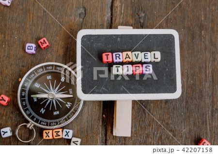 TRAVEL TIP word block on wooden signage 42207158