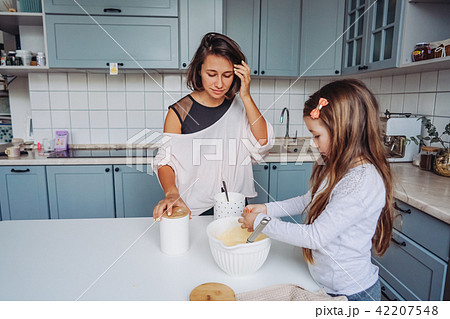 mom teaches her little daughter to cook food mom teaches her little daughter to cook food 42207548