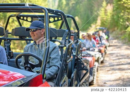 man riding atv vehicle on off road track ,people outdoor sport activitiies theme man riding atv vehicle on off road track ,people outdoor sport activitiies theme 42210415