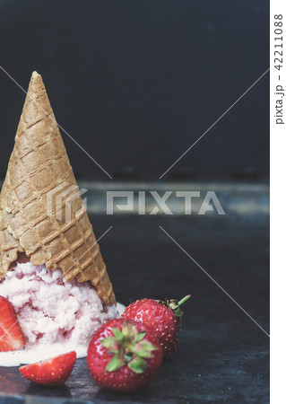 Strawberry ice cream in a waffle cone inverted 42211088