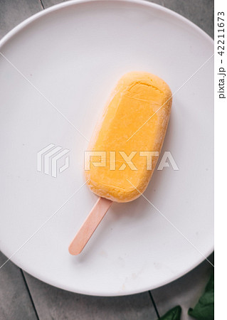 Raw mango popsicle and basil leaves 42211673