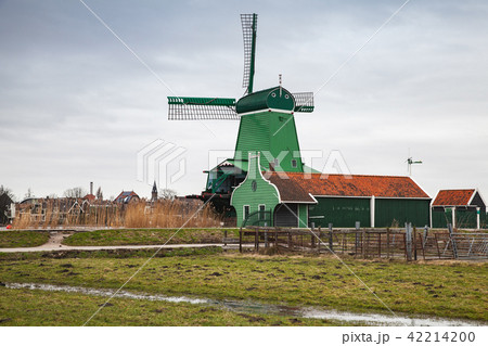 Old wooden Windmill near green barns Old wooden Windmill near green barns 42214200