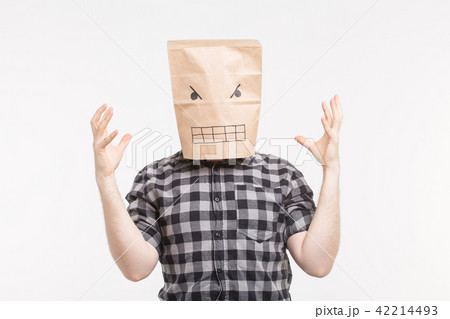 Angry man in paper bag mask on his head raising hands 42214493