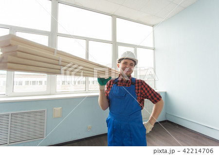 Portrait of handsome male builder laughing infront of window 42214706