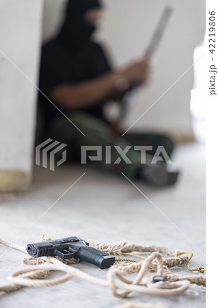 A gun is on the floor.  A gun is on the floor.  42219806