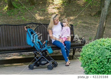 Mother walking while pushing a stroller in the 42220388