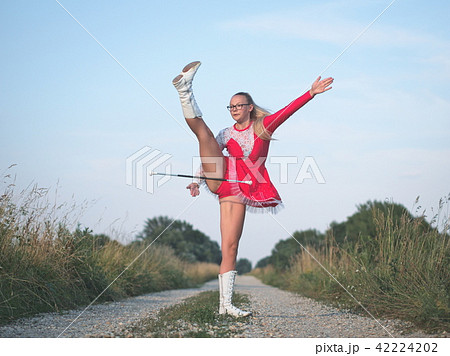 Teen Majorette Girl Twirling Baton Outdoors 42224202