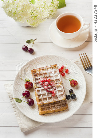 Homemade waffles with summer berries on a plate.  42227549