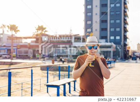 man with coffee frappe near sea feeling free enjoying freetime vacations man with coffee frappe near sea feeling free enjoying freetime vacations 42231667