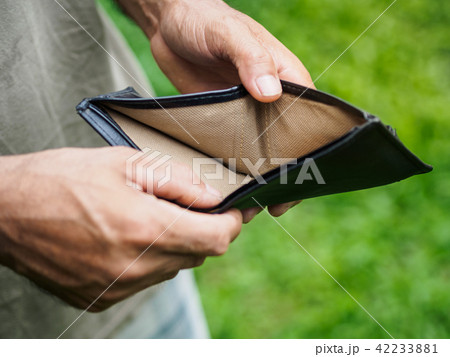 Unhappy bankrupt man with empty wallet 42233881
