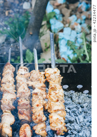 Cooking meat on the fire top view, shish kebab 42234477