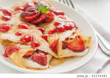 Thin pancakes, crepes wrapped with cheese, cream Thin pancakes, crepes wrapped with cheese, cream 42234481