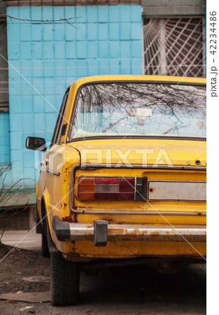 Near the wall is a blue yellow old Soviet machine 42234486