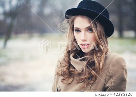 Nice fashion model woman in black hat outdoors 42235326