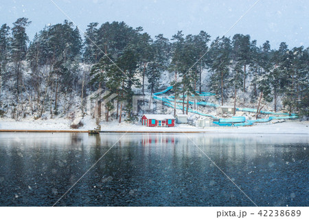Empty waterslide with red beach hut  42238689