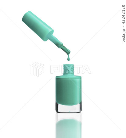 Nail polish dripping from brush into bottle 42242120