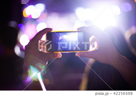 People taking photographs with smart phone People taking photographs with smart phone 42250309