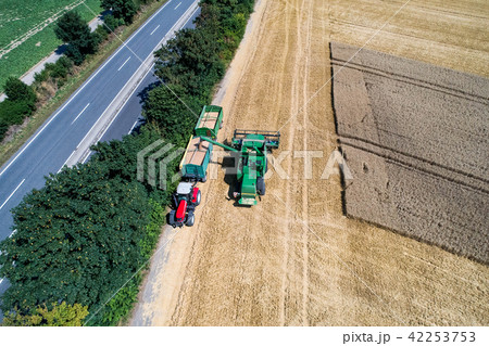 Aerial view on combine harvester working on the large wheat field in Germany 42253753