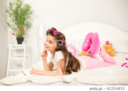 Girl writing in her notebook in bed. 42254833