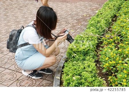 woman holding camera and taking picture 42255785