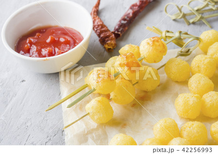 Cheese corn balls with spicy tomato sauce. Cheese corn balls with spicy tomato sauce. 42256993