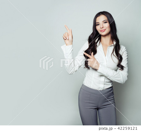 Young business woman pointing her finger up  42259121