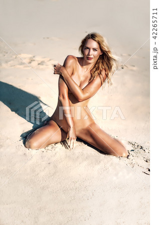 Beautiful girl model on sandy beach of the sea 42265711