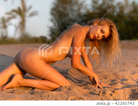 Beautiful girl model on sandy beach of the sea Beautiful girl model on sandy beach of the sea 42265743