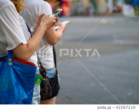 Woman using smartphone in the city Woman using smartphone in the city 42267210
