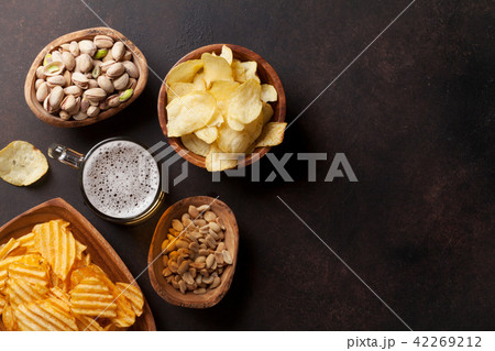 Lager beer and snacks on stone table Lager beer and snacks on stone table 42269212