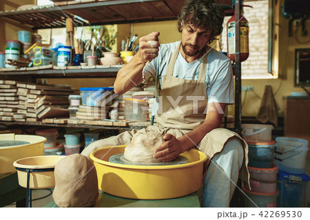 Creating a jar or vase of white clay close-up. Master crock. Creating a jar or vase of white clay close-up. Master crock. 42269530