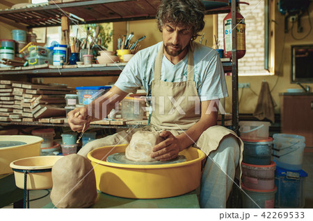 Creating a jar or vase of white clay close-up. Master crock. Creating a jar or vase of white clay close-up. Master crock. 42269533