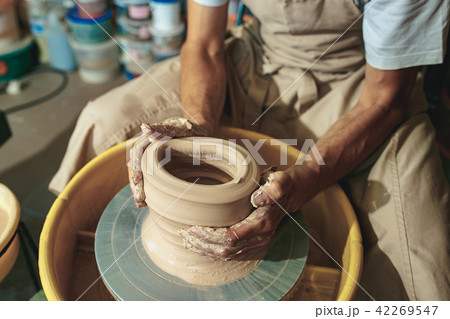 Creating a jar or vase of white clay close-up. Master crock. 42269547