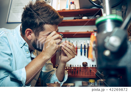 Different goldsmiths tools on the jewelry workplace. Jeweler at work in jewelry. 42269872