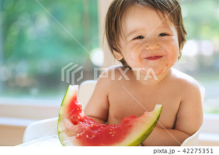 Toddler boy eating watermelon Toddler boy eating watermelon 42275351