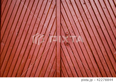 Old burgundy wooden door with handle and keyhole Old burgundy wooden door with handle and keyhole 42278844